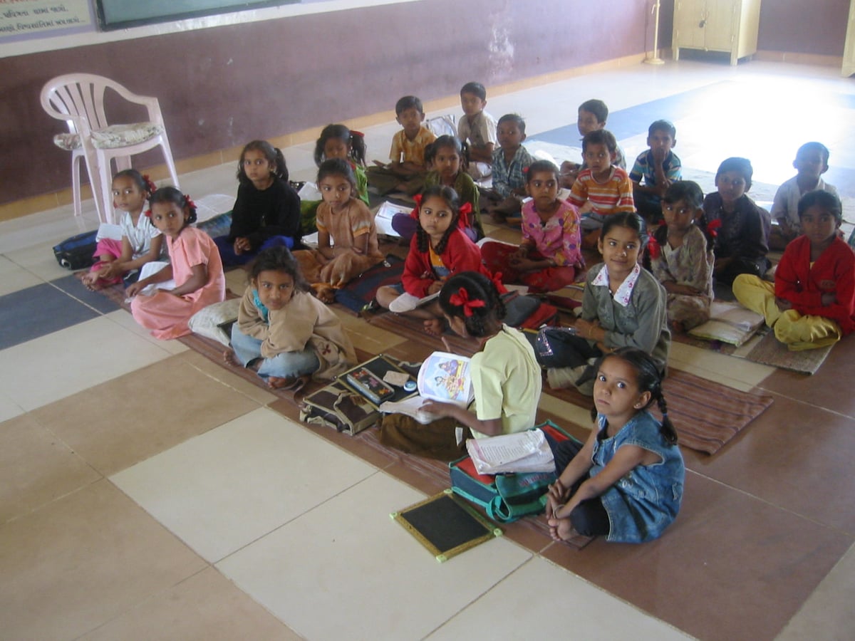 Children seated in a primary school classroom in Gujarat